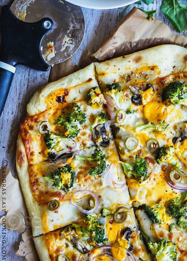 Artisan Pizza is an ultimately amazing veggie pizza topped with Broccoli, red onion, mushrooms, olives and two kind of cheese. Lunch perfection!